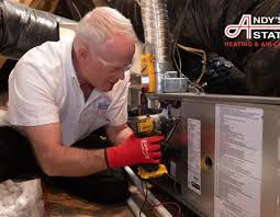 Heating technician inspecting a furnace and adjacent duct connections